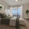 Spacious Bedroom with Private Balcony and Hardwood Style Floors