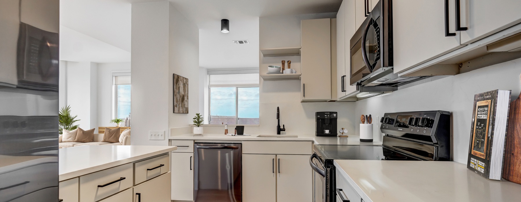 Modern kitchen with stainless steel appliances and quartz countertops