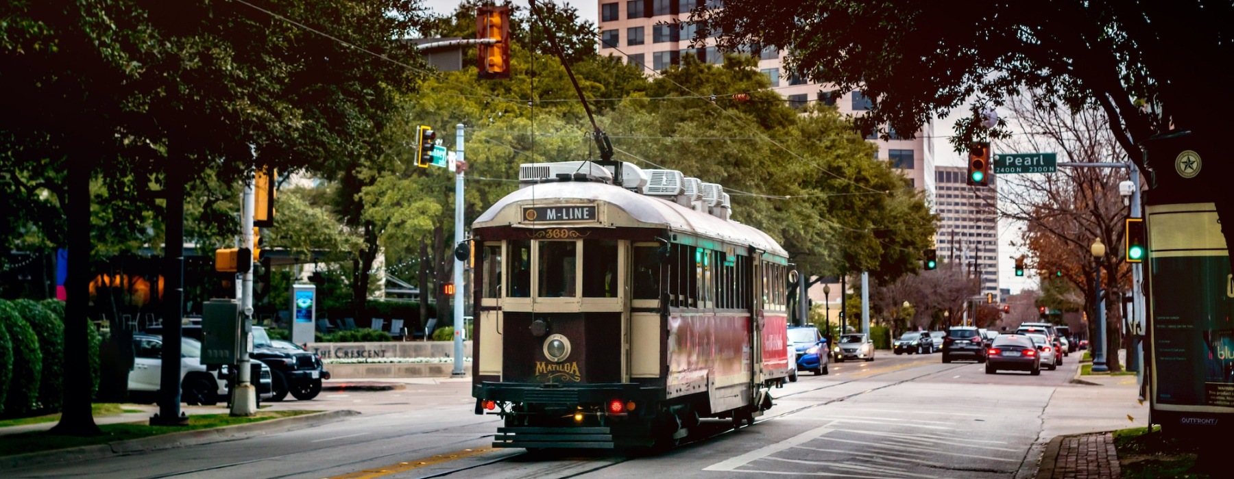 a trolley driving through a busy city street