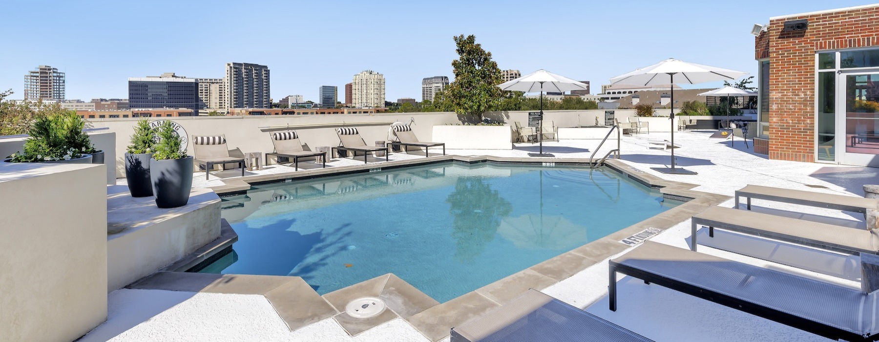 a swimming pool with lounge chairs